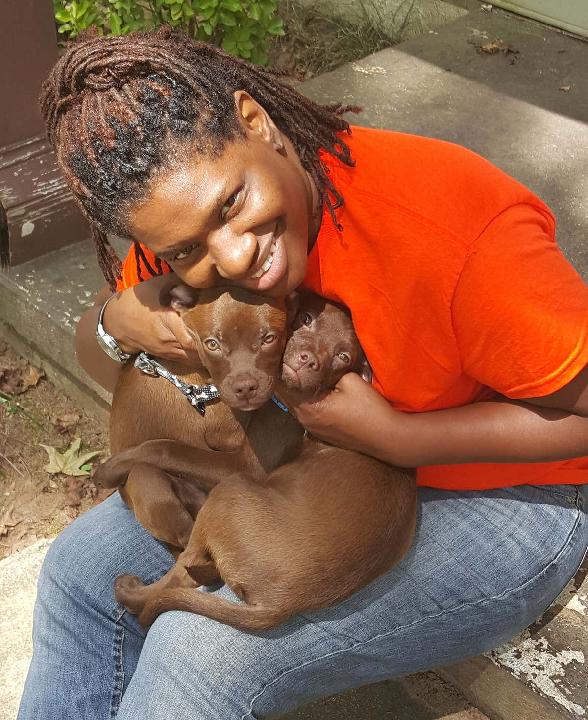 girl hugging puppies