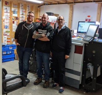 Specialized Marking System’s Owner Imran Fancy (right) with his production team and the company’s upgraded Mark Andy Digital Pro.