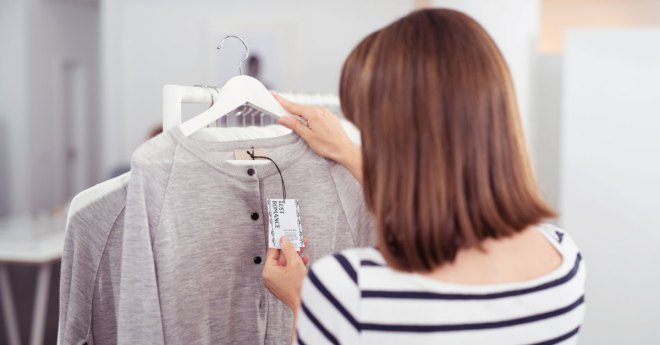 woman looking at a clothing tag design